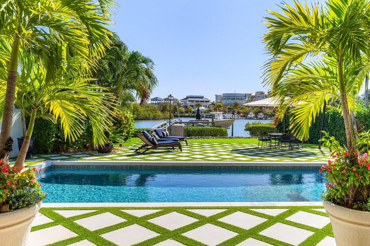 281 Fishermans Way Jupiter, FL 33477 - Photo 14 of 45 a view of swimming pool with lawn chairs plants and palm trees