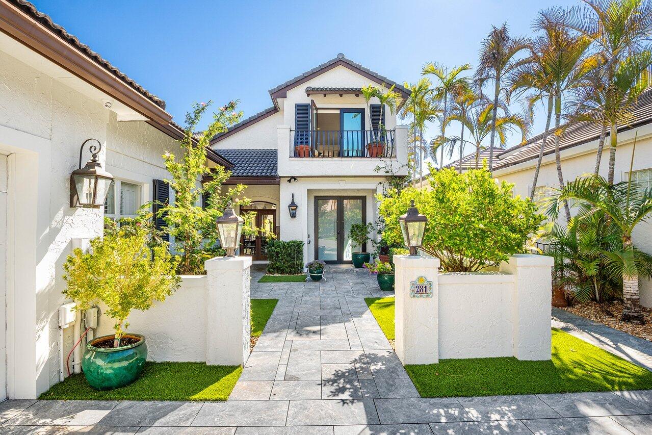 281 Fishermans Way Jupiter, FL 33477 - Photo 2 of 45 a front view of a house with a garden