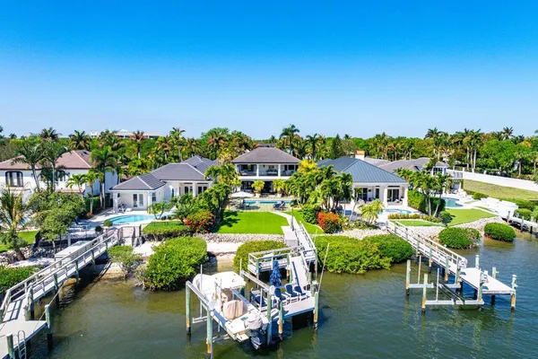 an aerial view of a house with a garden and lake view