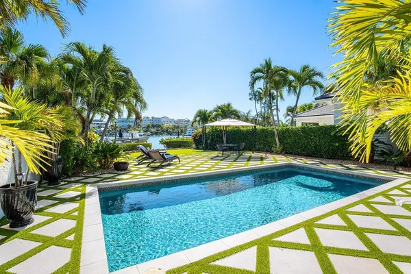 a view of swimming pool with a garden and patio