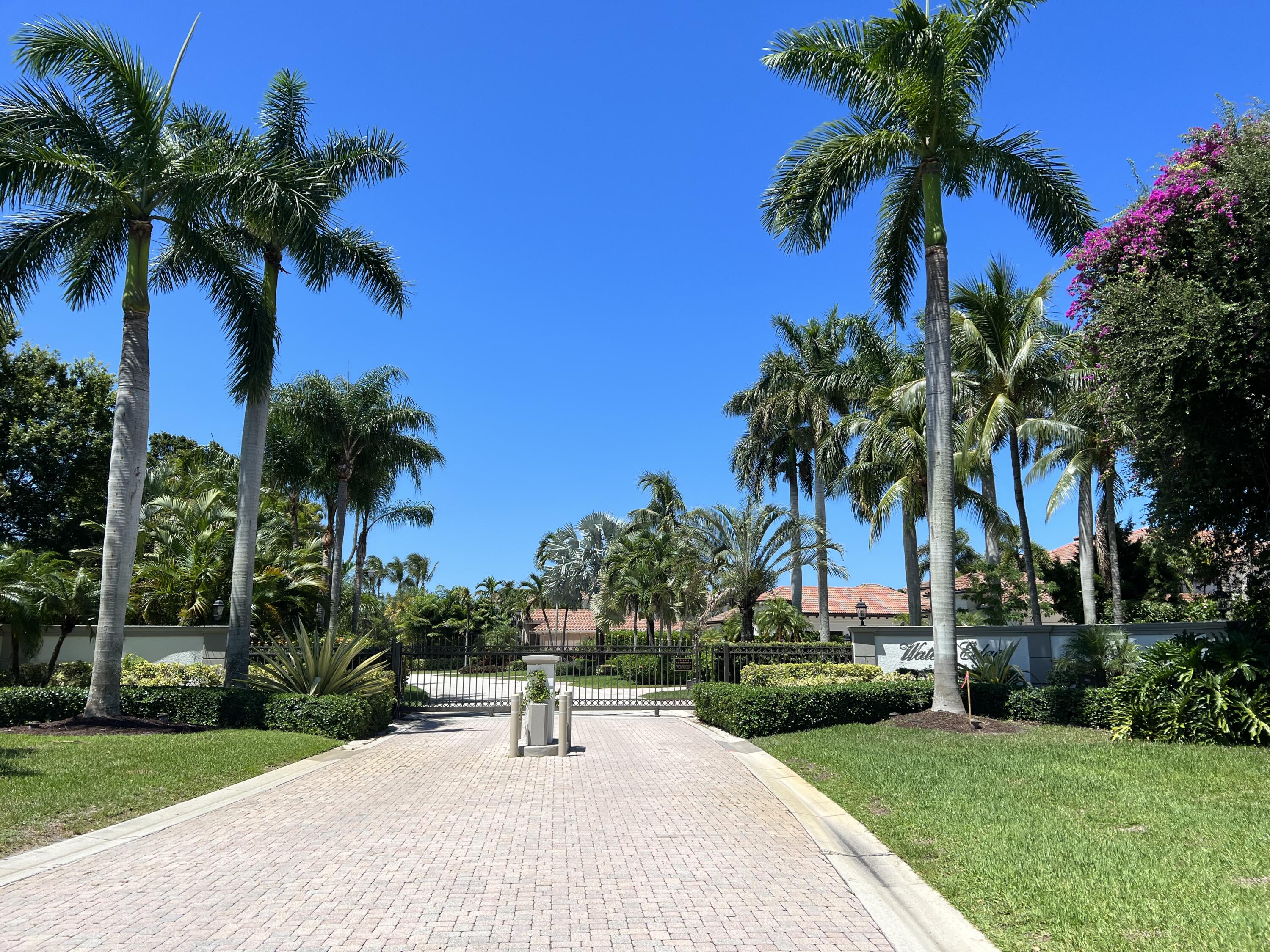 281 Fishermans Way Jupiter, FL 33477 - Photo 45 of 45 a palm tree sitting in front of a house with a yard