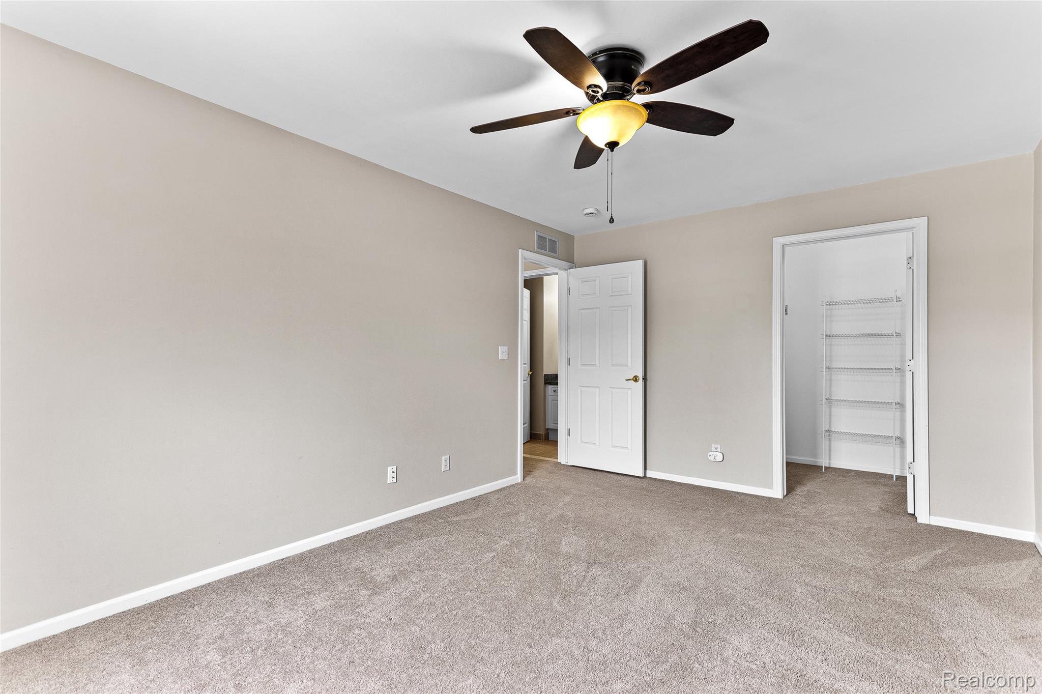 3553 Oakmonte Boulevard Rochester, MI 48306 - Photo 20 of 42 Carpeted room featuring a ceiling fan with light, neutral wall tones, and white trim