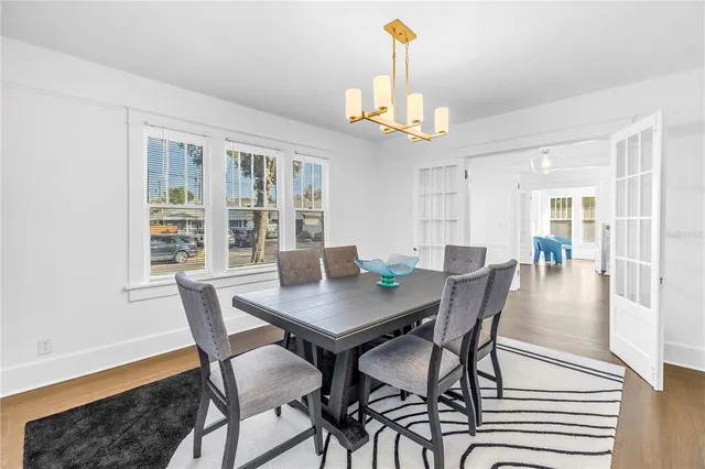 a view of a dining room with furniture window and wooden floor