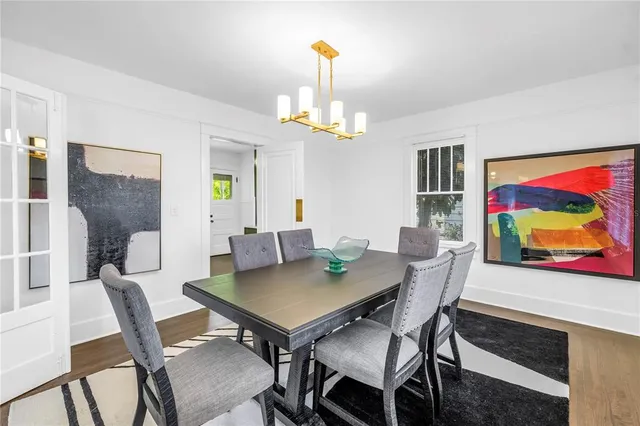 a view of a dining room with furniture wooden floor and a chandelier