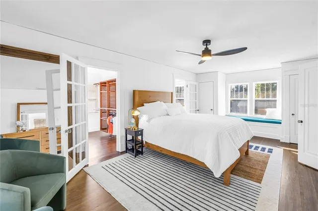 a spacious bedroom with a bed a couch and a window