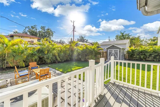 a view of a house with backyard and porch