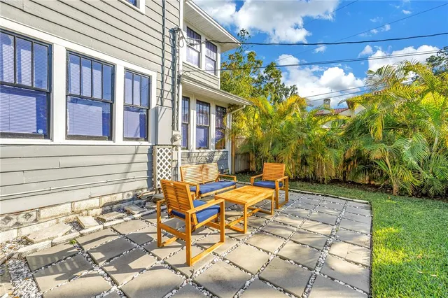 a view of a patio with table and chairs and potted plants