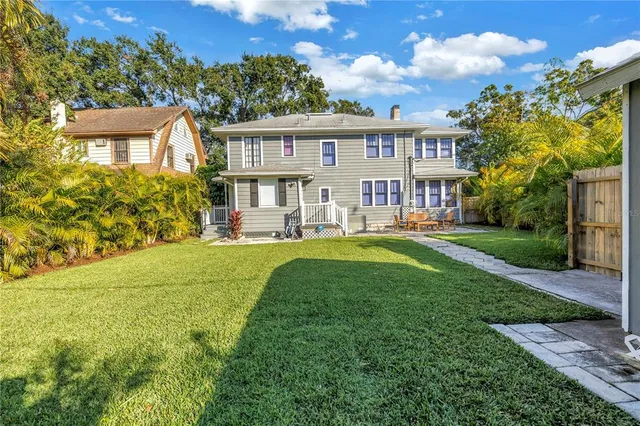 a house view with garden space and trees