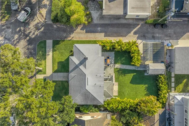 an aerial view of a house with a yard swimming pool and outdoor seating