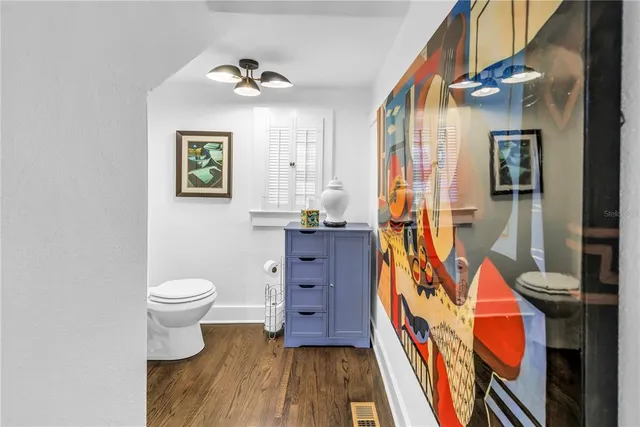 a bathroom with a toilet and a shower curtain