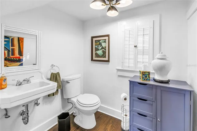 a bathroom with a sink a toilet and mirror