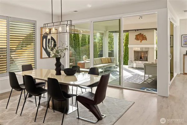 a view of a dining room with furniture wooden floor and a chandelier