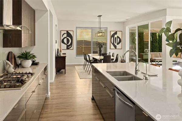 a kitchen with stainless steel appliances granite countertop a sink and a wooden floors