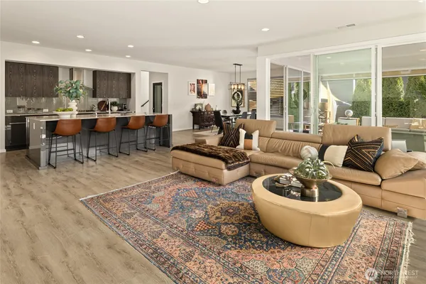 a living room with lots of chairs and a table