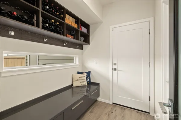 a hallway with wooden floor and furniture