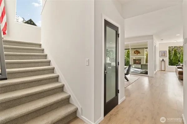 a view of entryway and hall with wooden floor