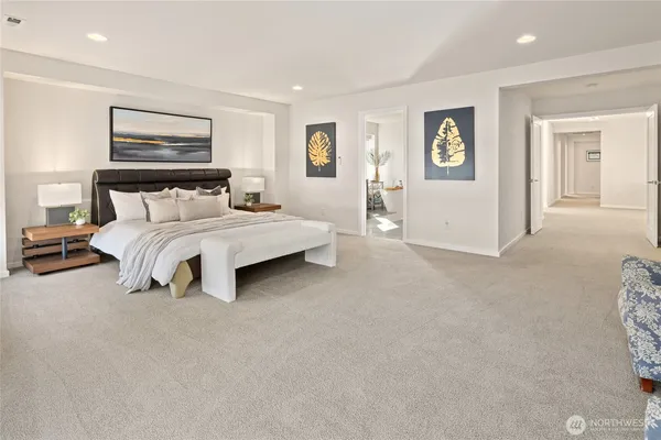 a spacious bedroom with a bed and a lamp