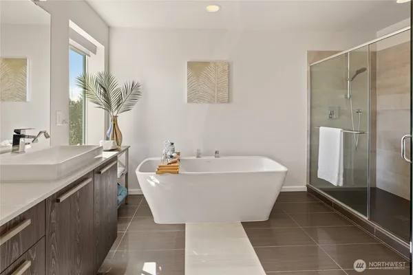 a spacious bathroom with a bathtub and sink
