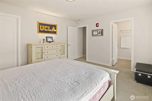 a bedroom with a bed and a desk