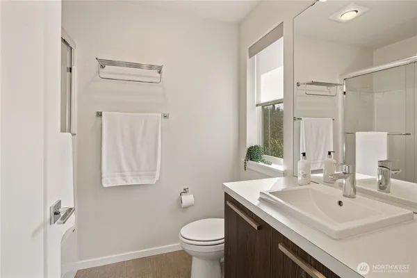 a bathroom with a sink toilet and a mirror