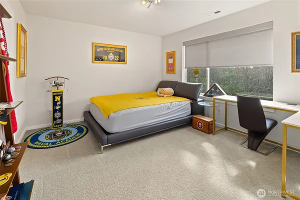 a bedroom with a bed and a table in it