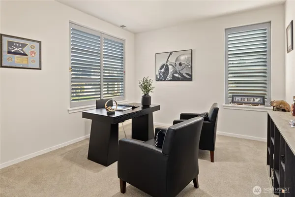 a view of a dining room with furniture and window