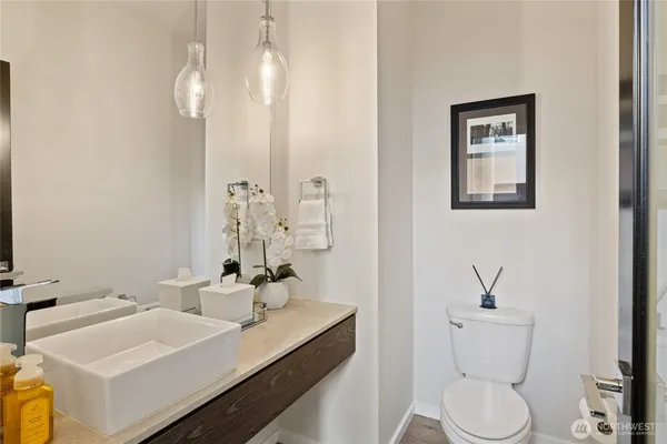 a bathroom with a toilet sink and mirror