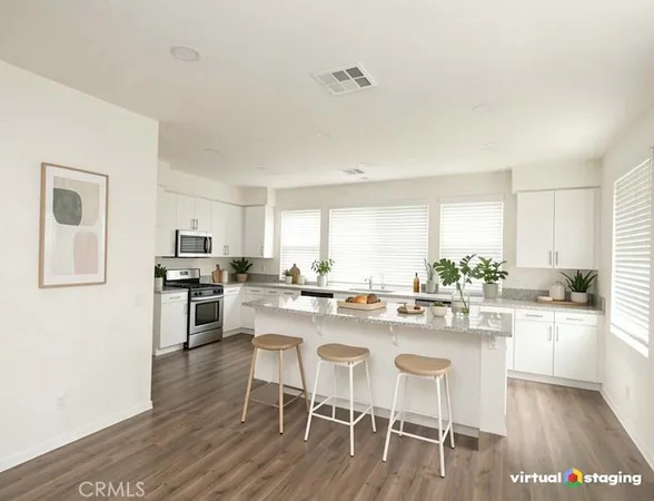 a kitchen with a dining table chairs and white cabinets