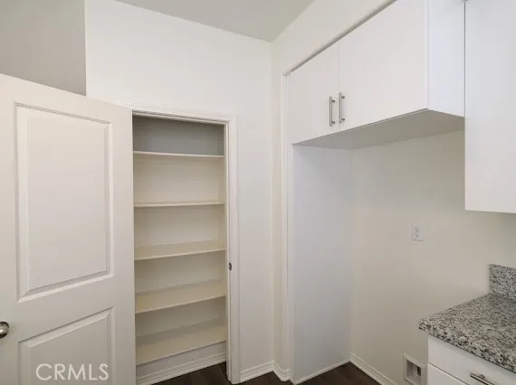a view of walk in closet with empty racks