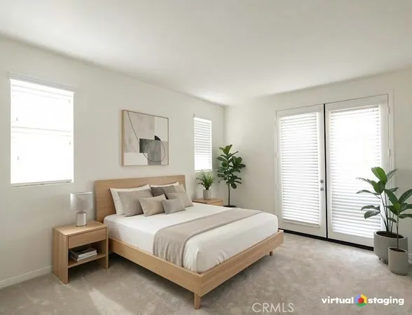 a bedroom with a large bed and a potted plant