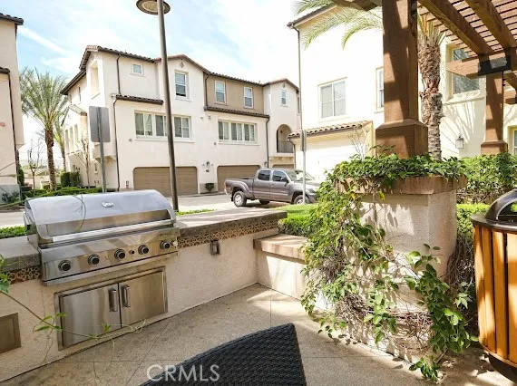 a view of a patio with table and chairs potted plants