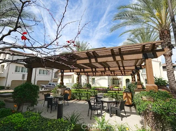 a view of a patio with table and chairs and potted plants