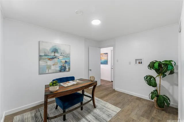 a dining room with furniture and potted plant
