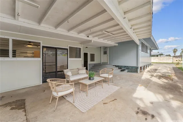 a view of a patio with dining table and chairs with wooden floor and fence