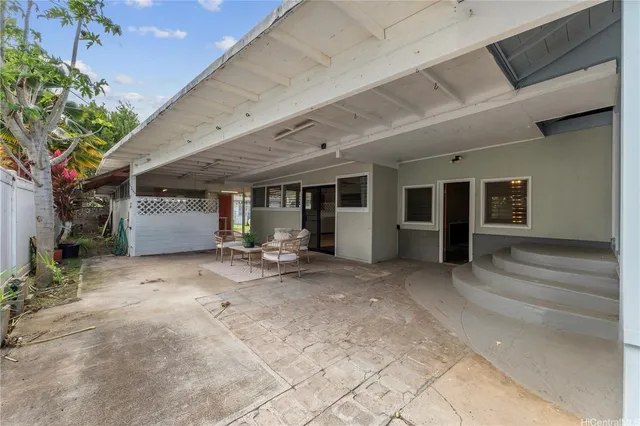 a view of a house with a patio and a garage