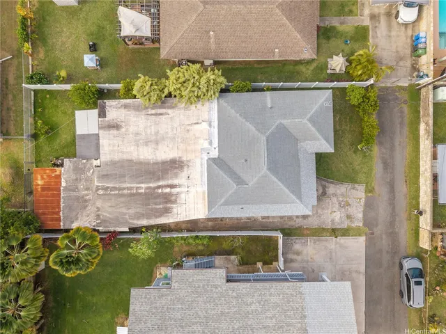 an aerial view of a house with a yard