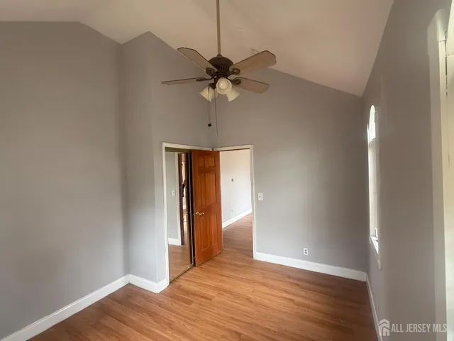 a view of a livingroom with a ceiling fan and wooden floor
