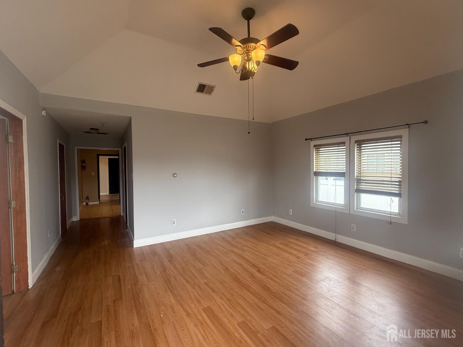 64 Fiat Avenue Iselin, NJ 08830 - Photo 12 of 25 a view of an empty room with wooden floor and a window