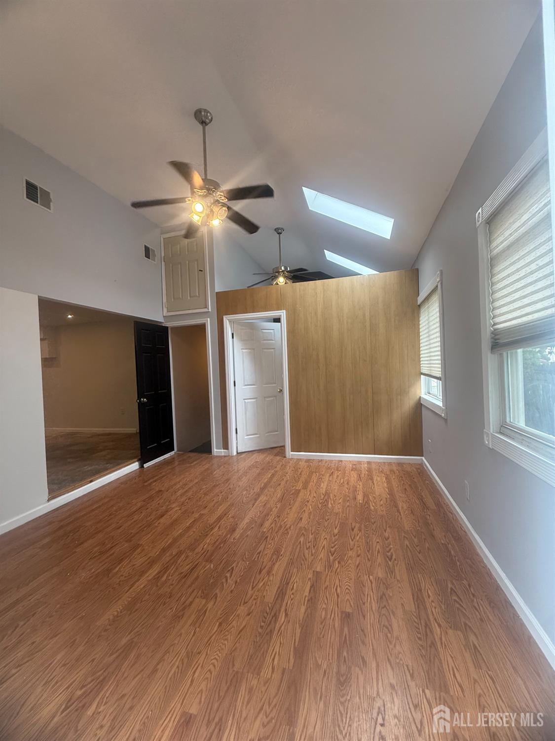 64 Fiat Avenue Iselin, NJ 08830 - Photo 13 of 25 a view of empty room with wooden floor and fan