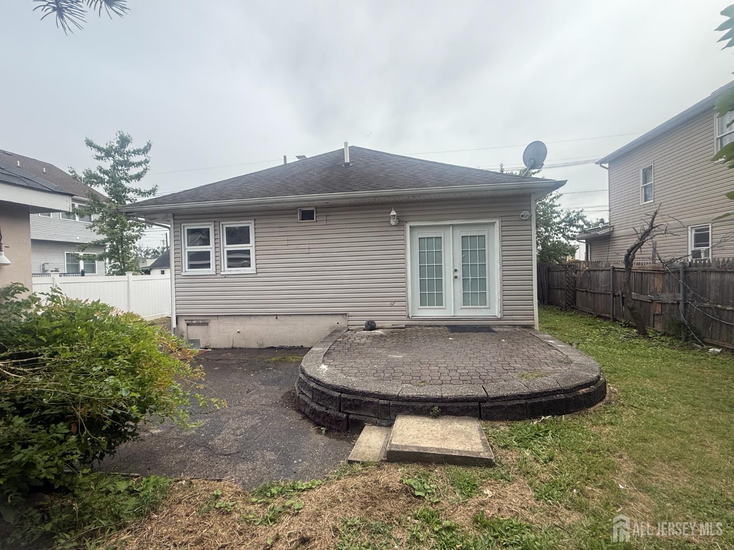64 Fiat Avenue Iselin, NJ 08830 - Photo 15 of 25 a view of a backyard with plants and brick wall