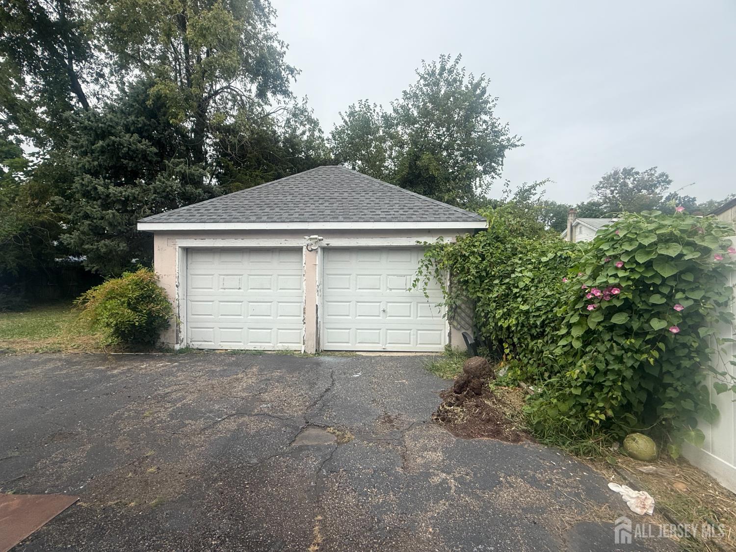 64 Fiat Avenue Iselin, NJ 08830 - Photo 16 of 25 a view of a house with a yard and garage