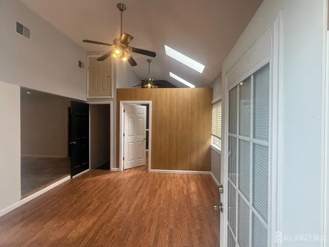 a view of an empty room with a fireplace and a window