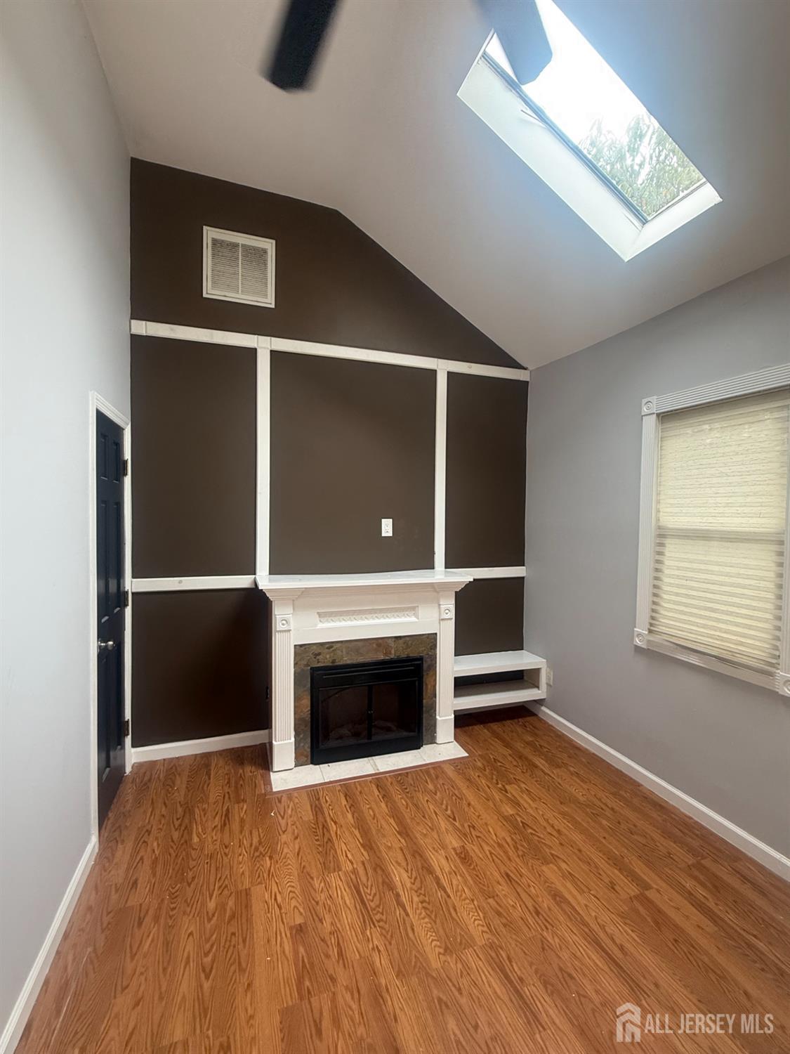 64 Fiat Avenue Iselin, NJ 08830 - Photo 19 of 25 a view of an empty room with a fireplace and a window