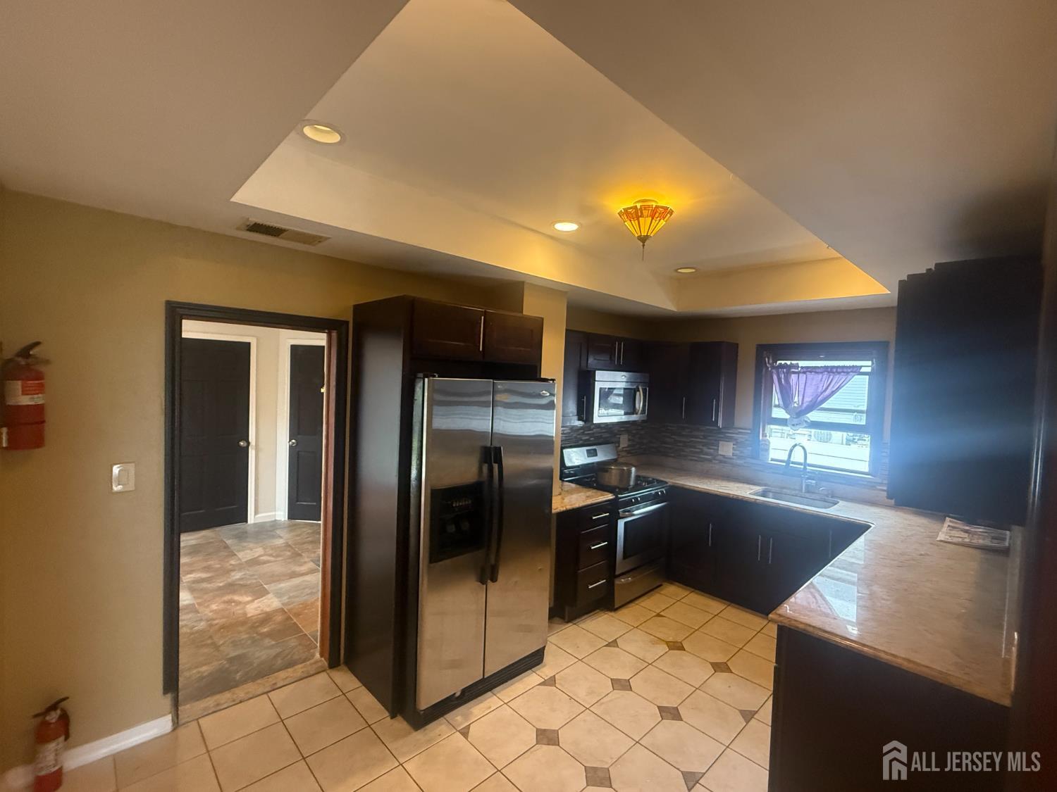 64 Fiat Avenue Iselin, NJ 08830 - Photo 2 of 25 a kitchen with stainless steel appliances kitchen island granite countertop a refrigerator a stove and a sink with granite countertops