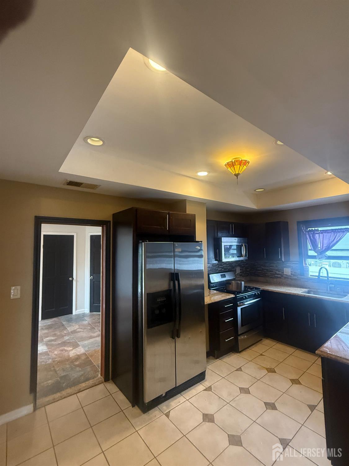64 Fiat Avenue Iselin, NJ 08830 - Photo 3 of 25 a kitchen with stainless steel appliances kitchen island granite countertop a refrigerator and a stove