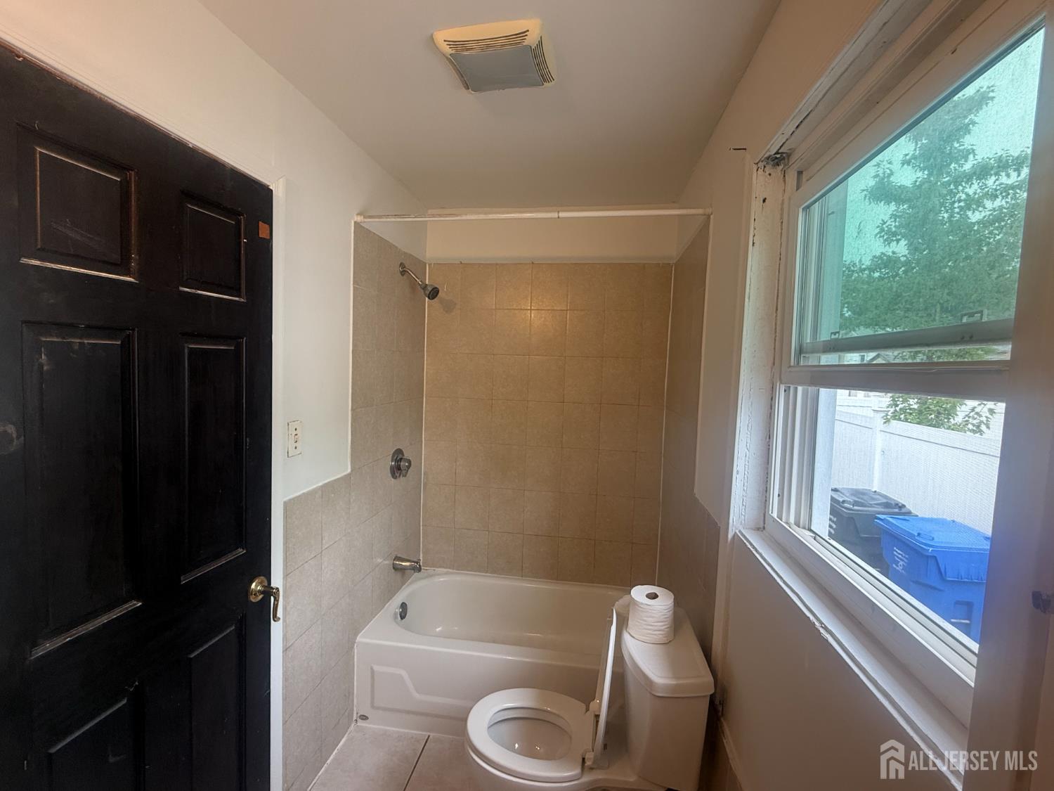 64 Fiat Avenue Iselin, NJ 08830 - Photo 6 of 25 a bathroom with a tub and a window