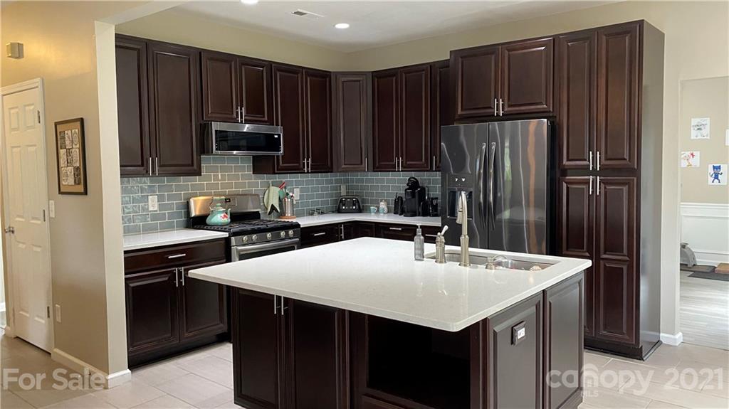 715 West Cheval Drive Fort Mill, SC 29708 - Photo 4 of 18 a kitchen with kitchen island a refrigerator sink and cabinets