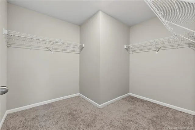 a bedroom with a bed dresser and a window