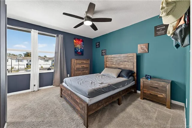 a bathroom with a granite countertop sink a toilet a mirror and shower