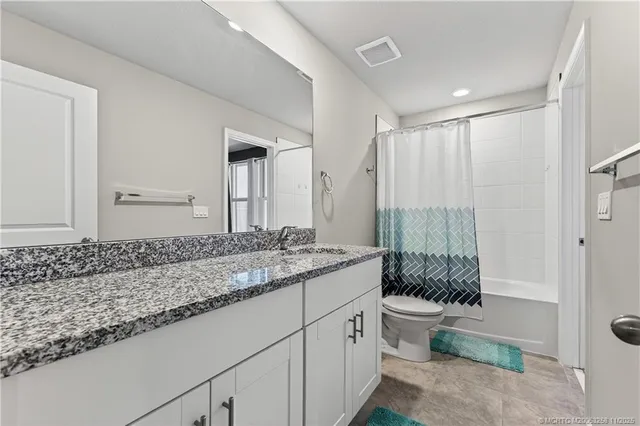 a view of a chair and tables in the patio